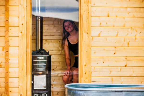 European Sauna at Maydena Bike Park Women in traditional european sauna next to harvia heater at maydena bike park