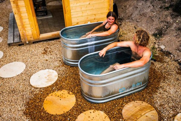 Maydena Bike Park Cold plunge ice baths couple in ice baths at maydena bike park next to traditional european sauna