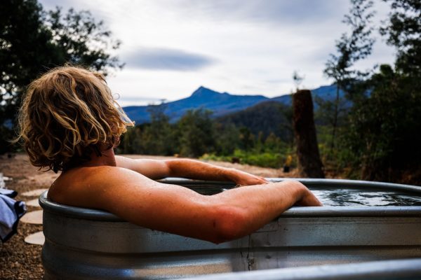 Recharge at Maydena Bike Park Ice Bath Mail in cold plunge ice bath looking at mountain views in background at maydena bike park wilderness wellness centre