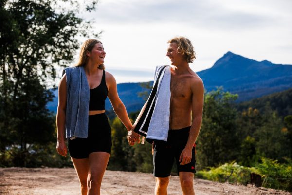 Relax at Maydena Bike Park Couple smiling surrounded by Derwent valley rainforest mountains at maydena bike park