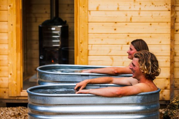 Wilderness Wellness Maydena Bike Park cold plunge and hot sauna Couple in separate ice baths at maydena bike park