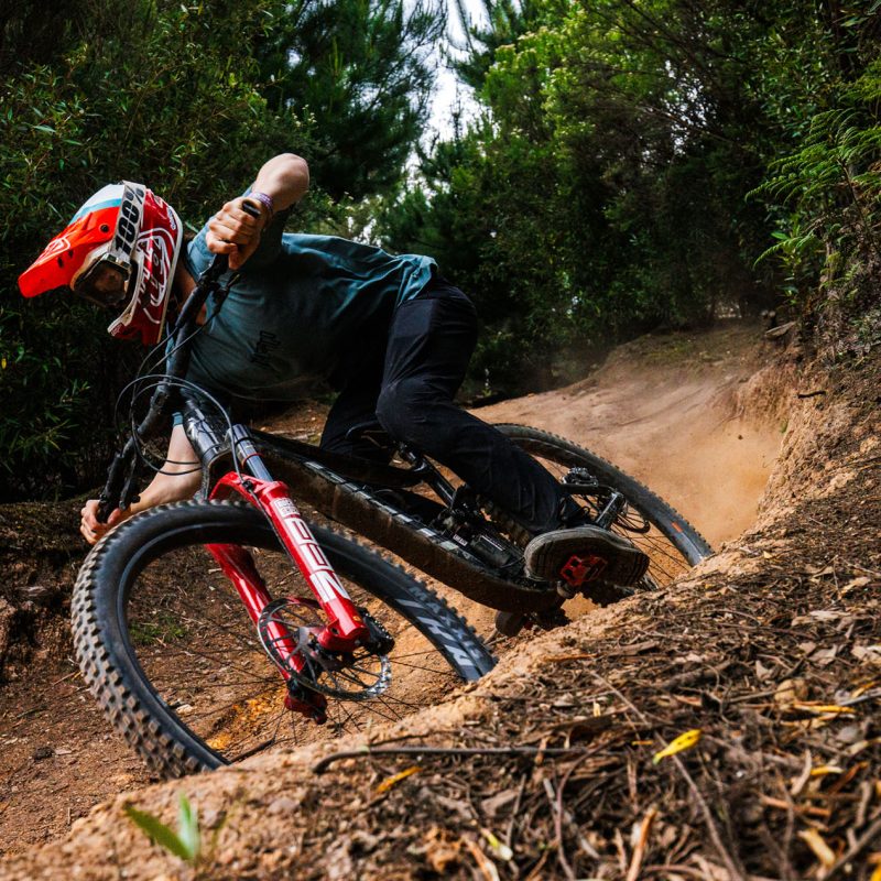 Enduro Mountain Bike rider riding a Giant hire bike on a berm on a flow trail in Australia - Maydena Bike Park